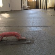 Concrete finishing tool on wet concrete